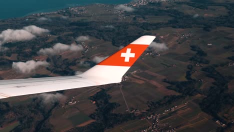 Airplane-window-view,-over-Switzerland