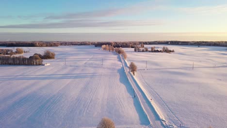Calm-Winter-Morning,-Snow-Covered-Fields-in-Golden-Hour,-Aerial-View