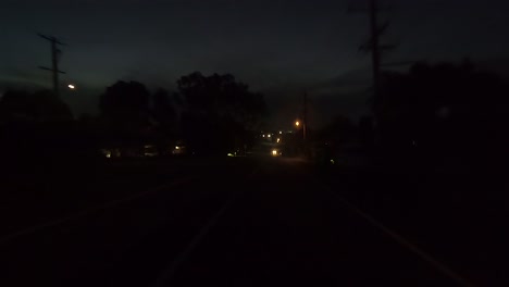 Rear-facing-night-driving-point-of-view-POV-for-interior-car-scene-green-screen-replacement---dark-and-quiet-suburban-street