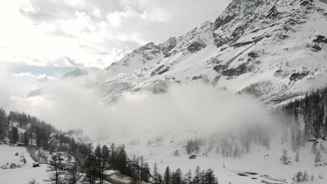 Aerial-landscape-view-of-snow-capped-mountains-in-Valle-D'Aosta,-in-the-italian-alps,-in-winter