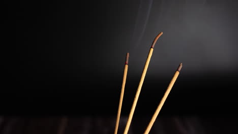 Time-lapse-of-burning-incense-sticks,-also-know-as-joss-sticks