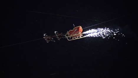 Santa-Claus-flying-over-a-christmas-market-with-firework-at-a-snowy-night-in-Kassel