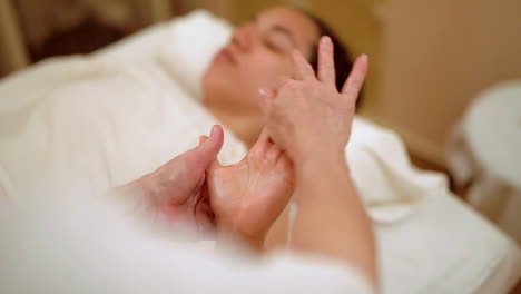 Freeing-knots-of-hand-while-massaging-during-therapy-spa