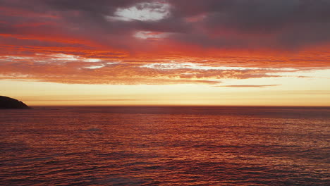 Dramatic-Orange-Sunset-Sky-Over-Sea-Horizon,-Bakoven-Beach,-Cape-Town-In-South-Africa