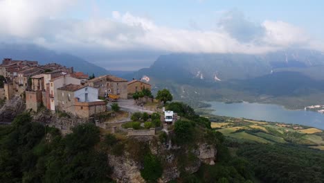 Llimiana,-Lerida,-Catalonia,-North-Spain---Aerial-Drone-Shot-of-a-Motorhome-at-the-top-of-a-Hill-with-Beautiful-View-at-the-Lake,-Valley-and-Mountains
