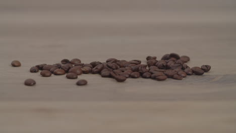 Close-up-slow-motion-cinematic-beautiful-shot-of-brown-roaster-coffee-beans-spinning-and-mixing-in-drum-roaster-on-slow-speed