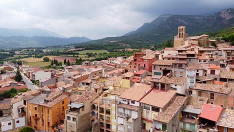 Rural-Village-at-Lerida,-Catalonia,-North-Spain---Aerial-Drone-View-of-the-Colorful-Village-and-Cloudy-Mountains