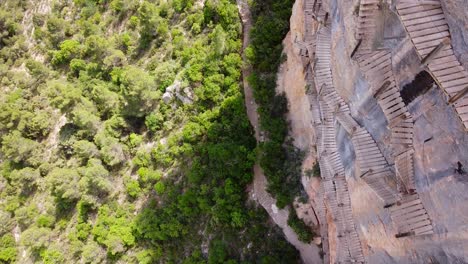 Pasarelas-de-Montfalco-at-Congost-de-Mont-Rebei-Canyon,-Catalonia-and-Aragon,-North-Spain---Aerial-Drone-View-of-the-Dangerous-Scary-Stairs-and-Hike-Trail-along-the-Steep-Cliffs