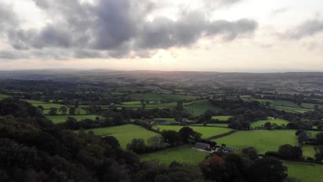 Aerial-forward-shot-of-the-Otter-Valley-in-East-Devon-England-with-a-dramatic-clouds-and-sunset