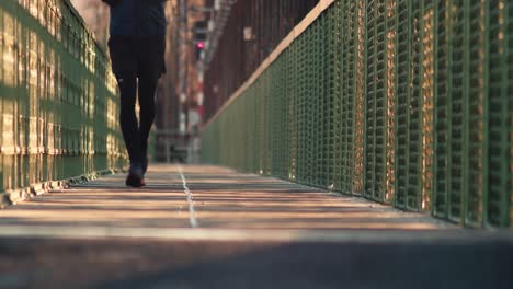 Male-runner-running-over-bridge,-closeup-front-view-of-legs,-Prague-healthy-lifestyle