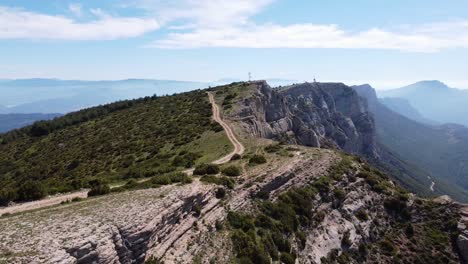 Ager,-Lerida,-Catalonia,-Spain---Aerial-Drone-View-at-the-Top-of-the-Mountain-Range-with-Beautiful-View-over-the-Green-Valley-and-Canyon