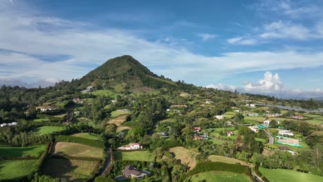 Valley-of-San-Nicolas,-Colombia,-Stunning-Green-Landscape,-Vacation-Homes-and-Agricultural-Fields-on-Sunny-Day---Drone-Shot