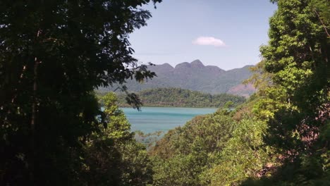 tropical-viewpoint-lush-forest,-ocean-mountains,-and-islands,-left-to-right-tracking-shot