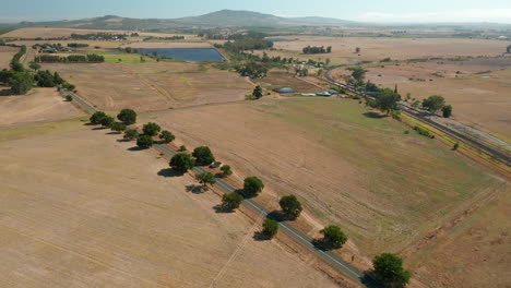 Aerial-Shot-Of-Car-Driving-Across-The-Road-On-Simonsberg-Nature-Reserve-Near-Wine-Estate-In-Stellenbosch,-Western-Cape-Province-Of-South-Africa
