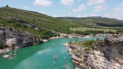 Congost-de-Mont-Rebei-Canyon-at-Ager,-Catalonia-and-Aragon,-Spain---Aerial-Drone-View-of-the-Blue-Emerald-Noguera-Ribagorçana-River,-Rocky-Mountains-and-Green-Valley