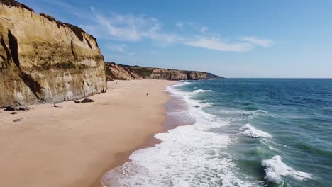 Praia-Das-Bicas-Beach-at-Castelo,-Alentejo,-West-Coast-Portugal---Aerial-Drone-View-of-the-Waves,-Sandy-Beach-and-Rocky-Coastline
