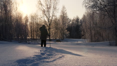 Silhouette-adventure-man-in-deep-snow-wilderness,scenic-rural-winter-landscape