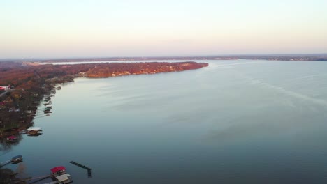 Drone-View-Over-Table-Rock-Lake-In-Midwest-Missouri-With-Calm-Blue-Water-and-Line-of-Floating-Docks-At-Vacation-Lake-Houses---aerial-shot