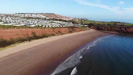 Aerial-panning-right-shot-of-Sandy-Bay-Holiday-Park-and-Straight-Head-Devon-England