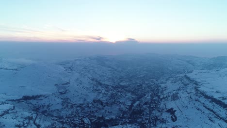 Faraya-mountainous-valley-covered-with-snow-at-dusk,-Aerial-of-Lebanon