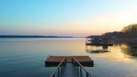 Moving-Across-Wooden-Floating-Dock-and-Bridge-By-The-Lakeshore-Of-Grand-Lake-O'-the-Cherokees-In-midwest-Oklahoma-at-Sunset