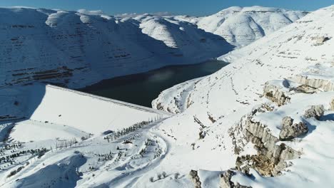 Faraya-Chabrouh-Dam-full-of-water-under-white-snowy-landscape