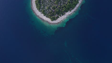 Tropical-pristine-island-in-clear-blue-Adriatic-sea-water,-aerial
