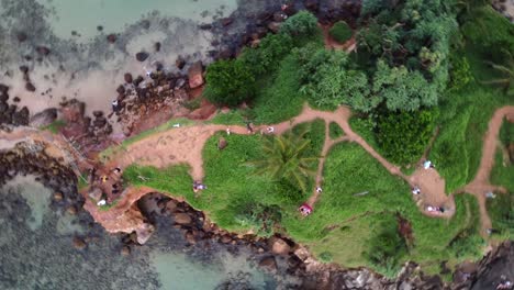 Orbit-Top-Down-Shot-Of-Tourists-Exploring-Exquisite-Pigeon-Island-Mirissa,-Sri-Lanka