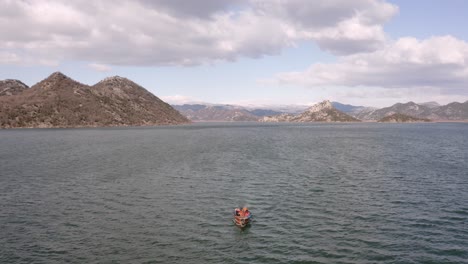 AERIAL---Boat-ride-on-beautiful-Lake-Skadar,-Montenegro,-wide-tracking-shot