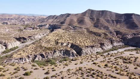 Tabernas-Desert-in-Almeria,-Andalusia,-Spain---Aerial-Drone-View-of-the-Dry-Valley,-River-Bed,-Mountains-and-Theme-Park-Western-Leone