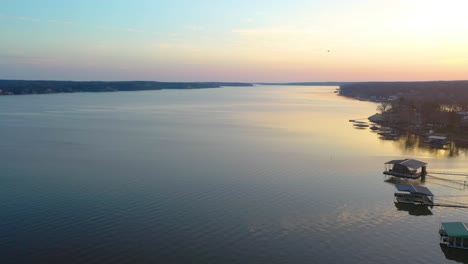 Bird-Flying-Across-Calm-Waters-Of-Grand-Lake-O'-the-Cherokees-In-Oklahoma-At-Sunset---aerial-drone-shot