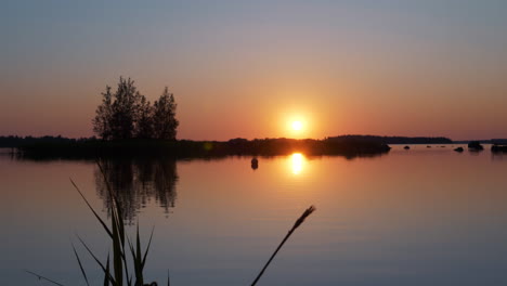 Stunning-sunrise-reflected-on-lake-in-Vaasa,-Finland