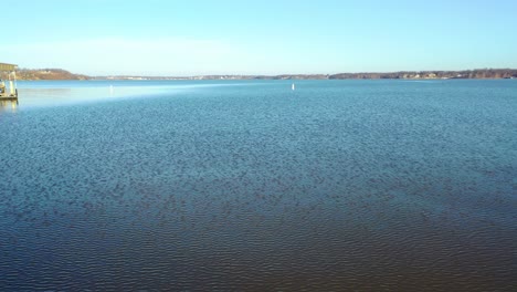Drove-View-Of-Two-No-Wake-Buoys-For-Boat-Navigation-In-Cove-Or-River-Channel-On-Table-Rock-Lake-in-Midwest-Missouri-With-Ripples-From-Wind-On-Beautiful-Clear-Blue-Water