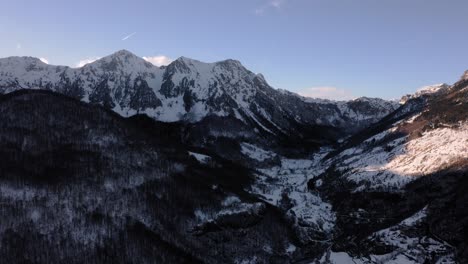 AERIAL---Beautiful-snowy-winter-in-the-valley-around-Kolasin,-Montenegro,-forward