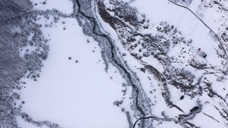 AERIAL---Snowy-winter-in-the-mountains-around-Kolasin,-Montenegro,-circling-top-down