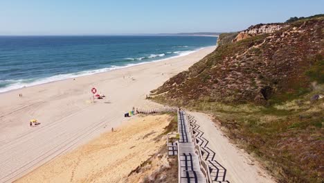 Praia-Das-Bicas-Beach-at-Castelo,-Alentejo,-West-Coast-Portugal---Aerial-Drone-View-of-the-Long-Staircase-to-the-Golden-Sandy-Beach-and-Rocky-Coastline