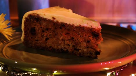 Slice-Of-Delicious-Vegan-Carrot-Cake-In-A-Plate-With-Light-Decorations-On-The-Table