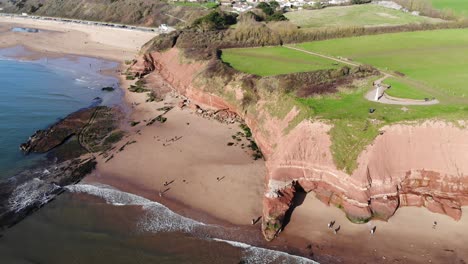Aerial-panning-left-shot-of-the-cliffs-at-Orcombe-Point-Exmouth-Devon-England