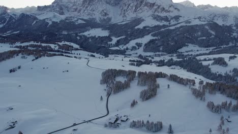 Reveal-shot-of-Langkofel-Group-mountain-range-in-Alps-during-early-morning-sunrise,-aerial