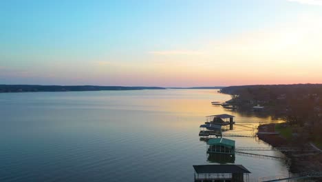 Drone-Takeoff-From-Wooden-Floating-Docks-for-Beautiful-View-or-Grand-Lake-O'-the-Cherokees-In-Midwest-Oklahoma-During-Sunrise-with-Glass-Calm-Water---aerial-ascending