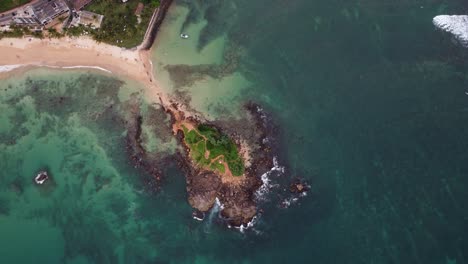 Aerial-top-down-over-Pigeon-Island-rocky-shore,-sand-beach-and-turquoise-sea-at-daytime,-Sri-Lanka