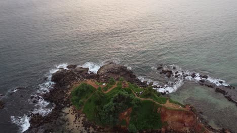 Aerial-Drone-Panning-Over-Tropical-Rocky-Beach-Coast,-Ocean-And-Town-In-Mirissa-Beach,-Sri-Lanka-Tourist-Holiday-Destination