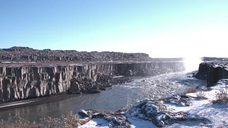 Rocky-canyon-below-the-Dettifoss-river-waterfall-in-winter,-Iceland