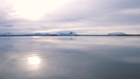 Sunrise-over-still-waters-of-lake-Myvatn-and-mountains-around,-Iceland