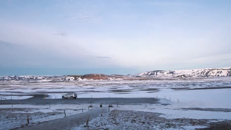 Silver-car-parked-on-a-road-in-frozen-volcanic-plain,-Myvatn,-Iceland