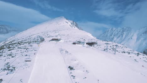 Magnífica-Vista-Aérea-De-Drones-Que-Se-Eleva-Sobre-El-Sendero-De-La-Pista-De-Esquí-Del-Parque-Nacional-Tatra,-Adelante-Revela-Un-Impresionante-Paisaje-Montañoso-Nevado,-Día