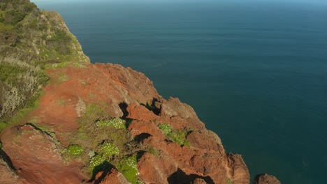 Jagged-orange-sandstone-landscape-on-cliff-shore-in-Madeira,-Atlantic-Ocean-view,-aerial