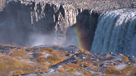 Sunlight-forming-a-rainbow-in-Dettifoss-waterfall-canyon-in-Iceland