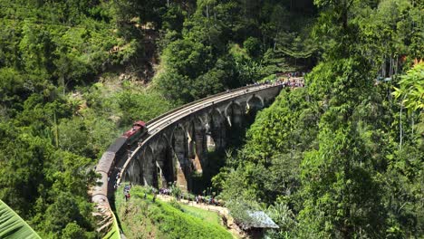 Slow-Motion-Shot-Of-Vintage-Train-Crossing-Nine-Arches-Historical-Bridge,-Ella-Sri-Lanka