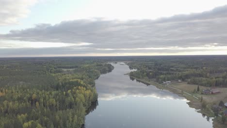 Aerial-backwards-view-of-forest-along-the-river